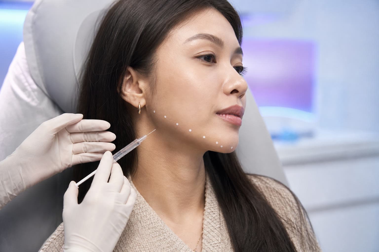 Facial mapping with marking points along the jawline before doctor-led contouring